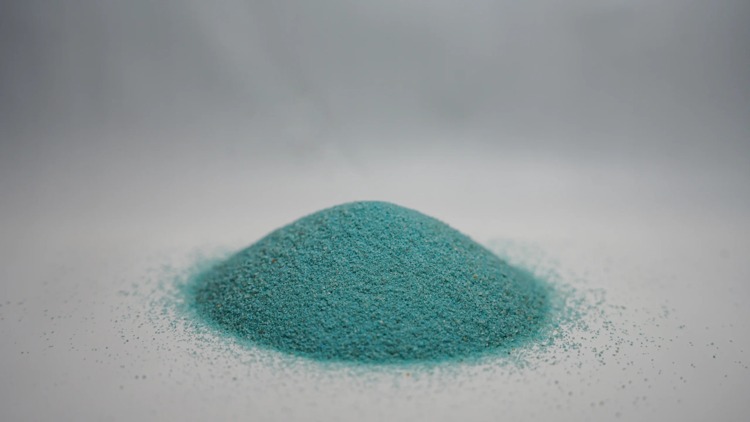 A small mound of fine sky blue sand