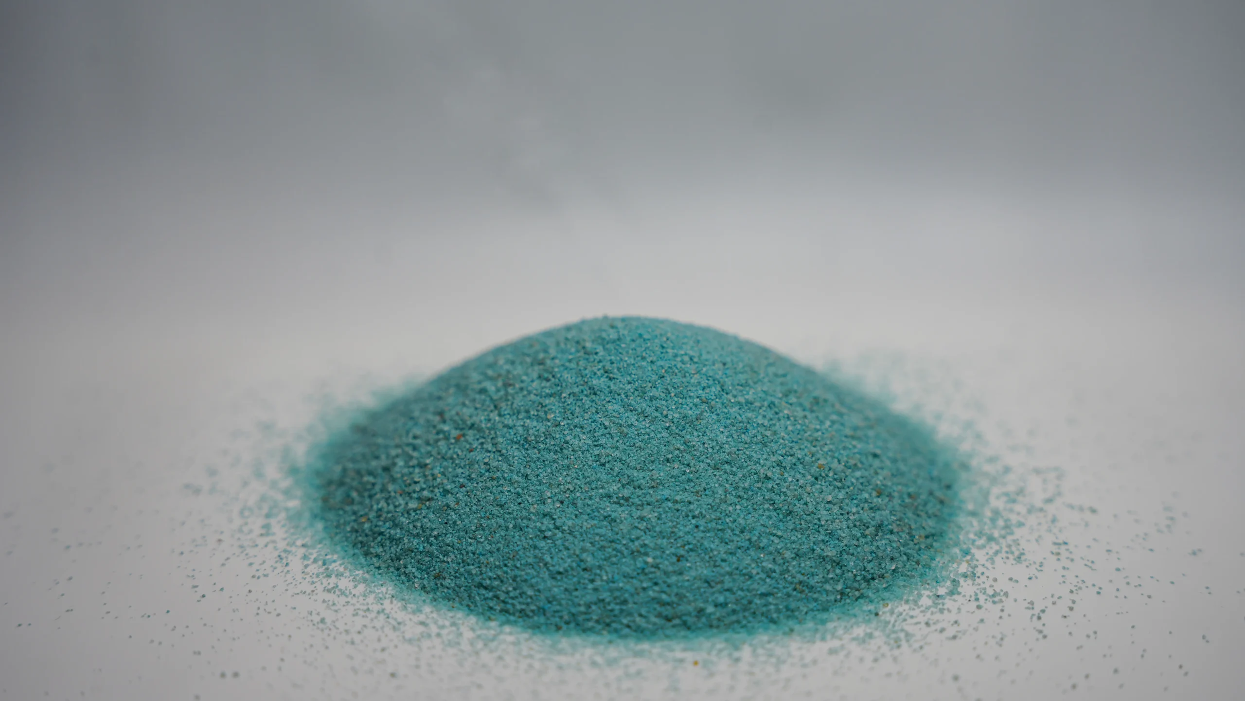 A small mound of fine sky blue sand