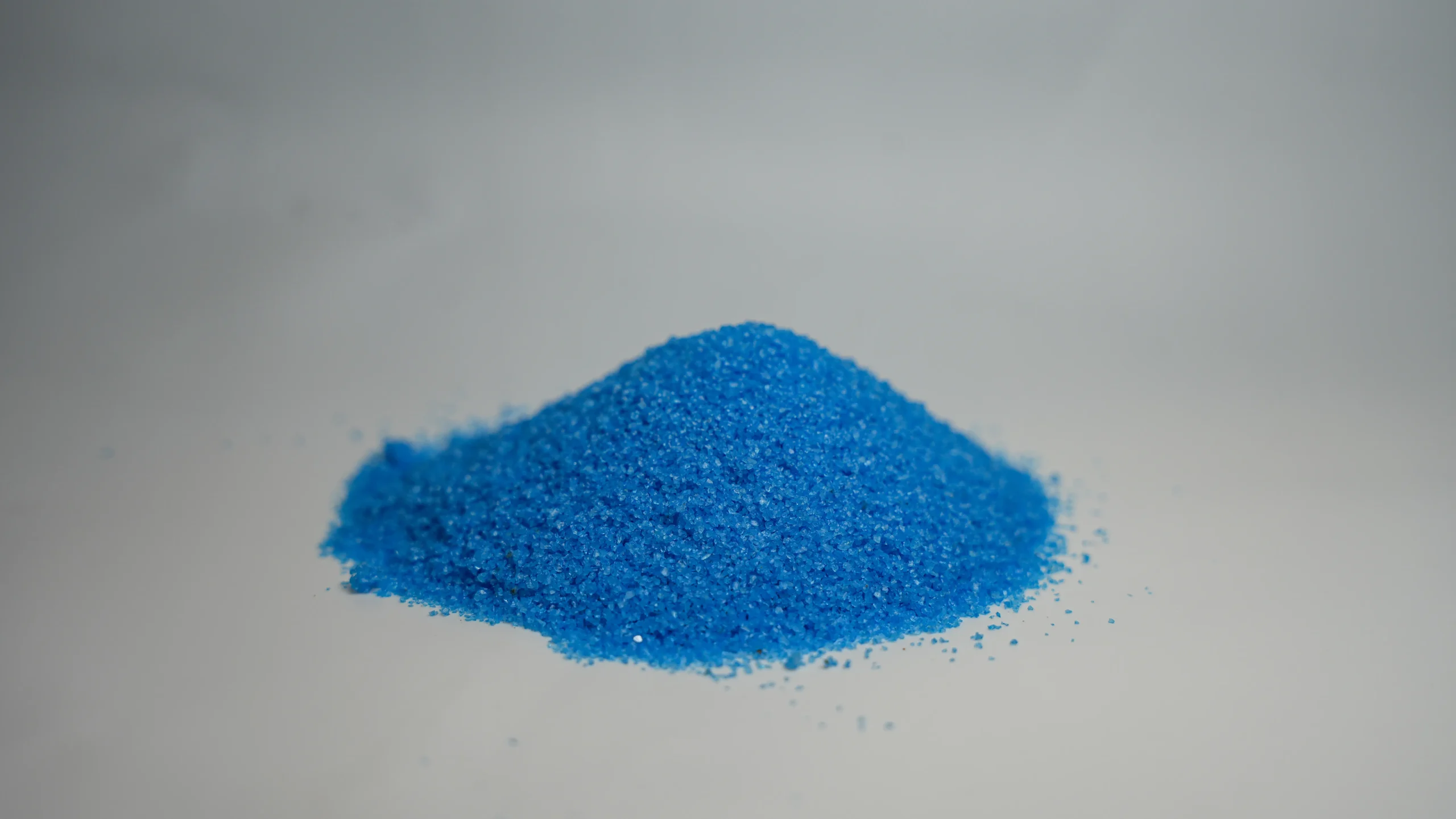 A small mound of light blue sand
