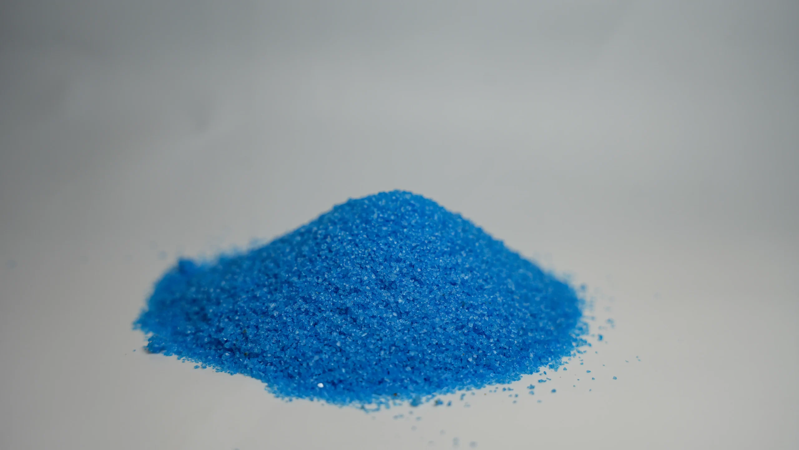 A small mound of light blue sand