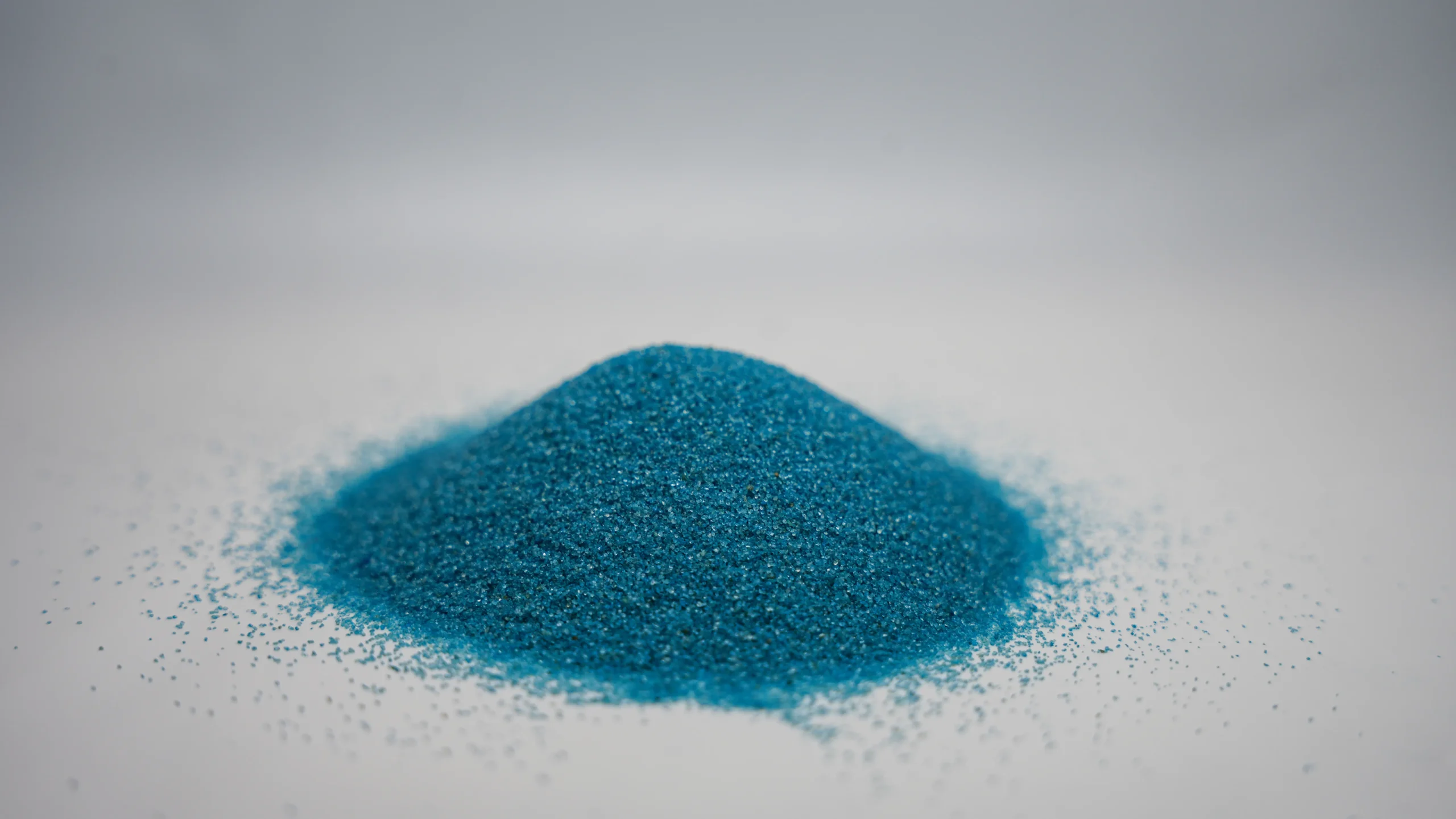 A small mound of fine sky blue sand
