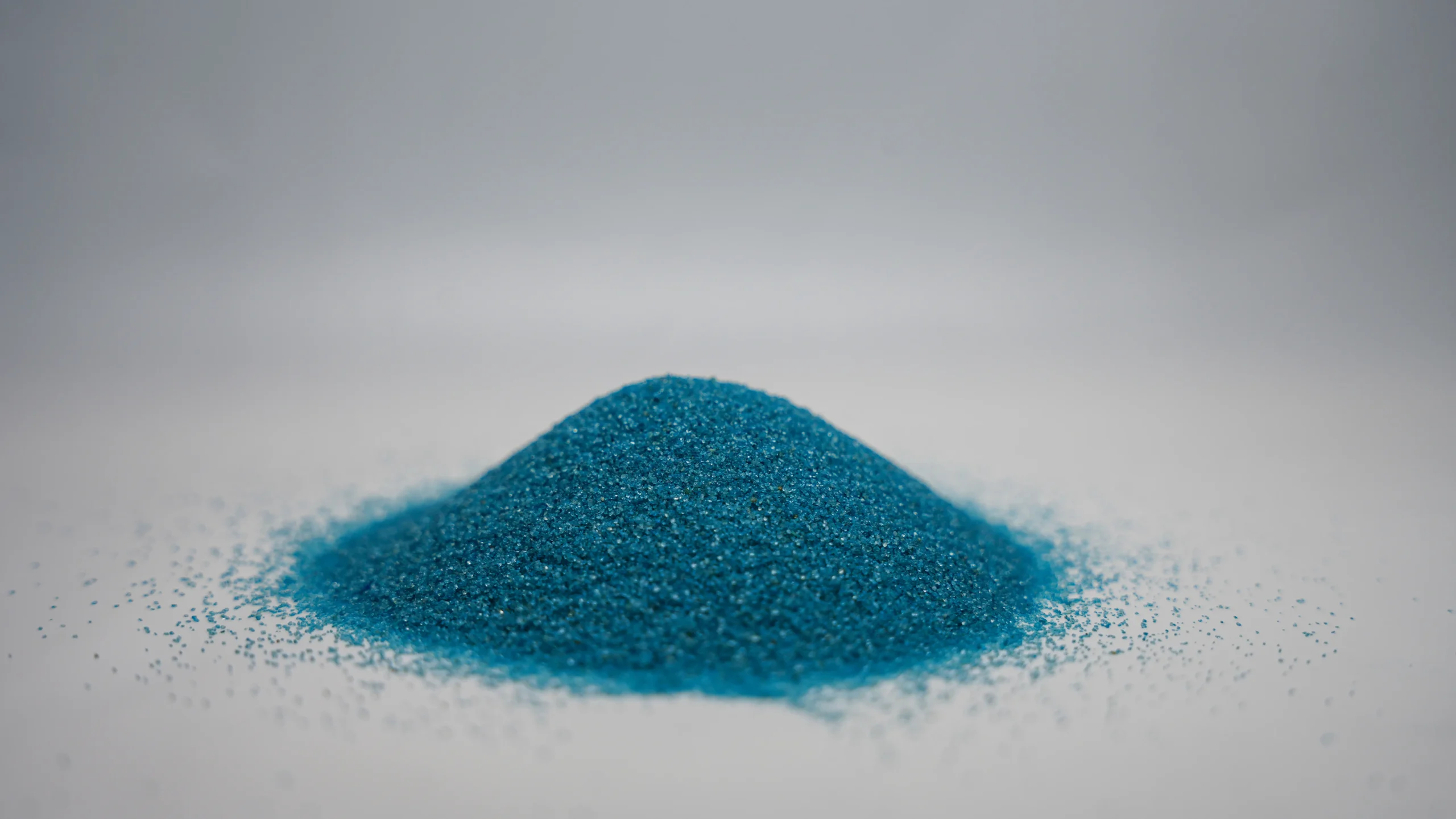 A small mound of fine sky blue sand