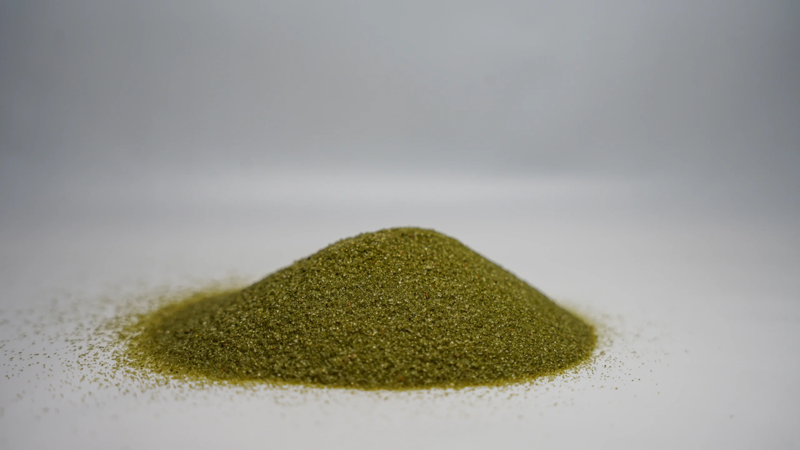 A small mound of fine green abrasive sand