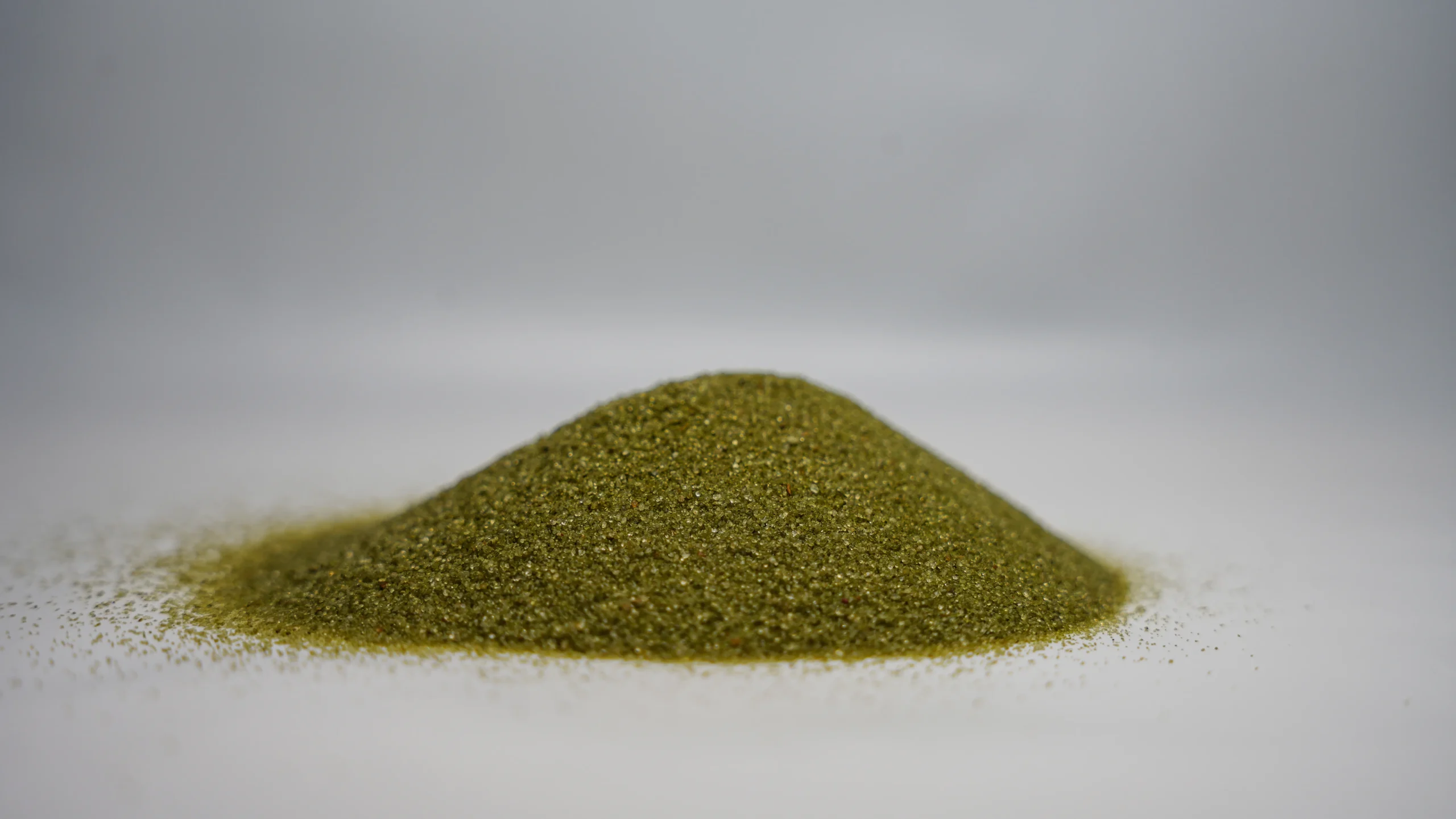 A small mound of fine green abrasive sand